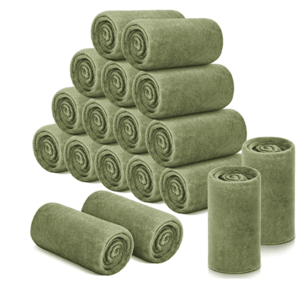 A group of rolled up green blankets stacked on top of each other.